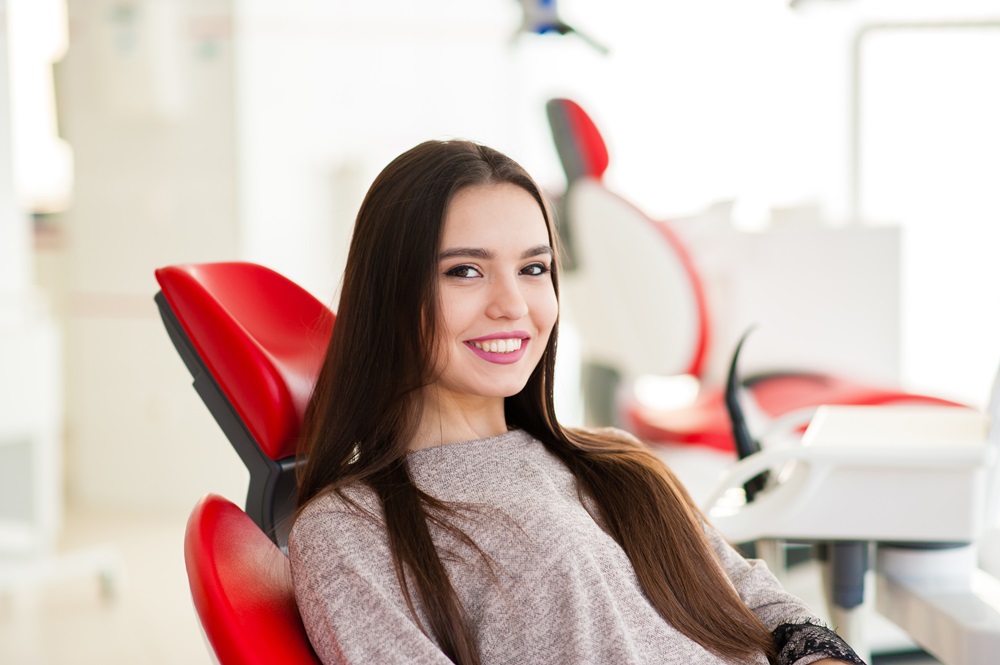 woman smiling after getting teeth bonding